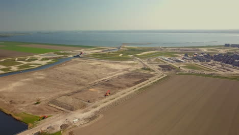 aerial drone shot of tilting up on the flat landscape near the coastline in the netherlands
