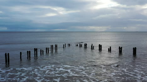 aerial flight slowly moving forward over sea defences, groynes part 1