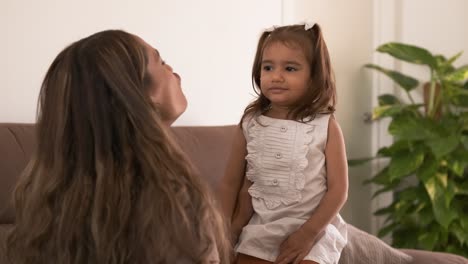 cheerful woman and daughter making a face at home