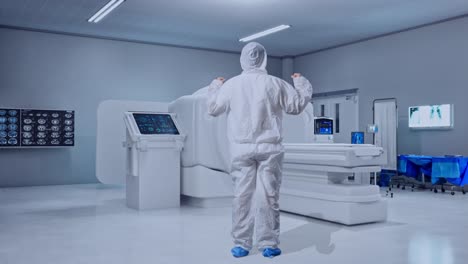full body back view of asian male scientist celebrating the succeed while standing with mri machine in the hospital