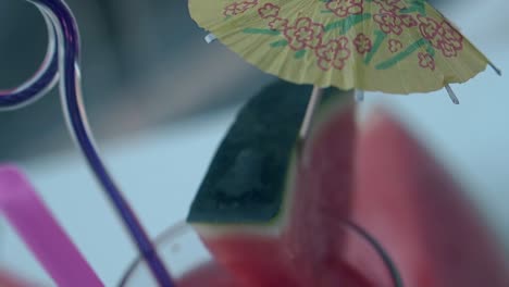 watermelon drink stands on white surface with plastic straws