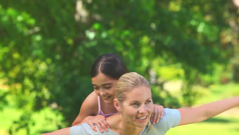 Young-woman-playing-with-her-daughter