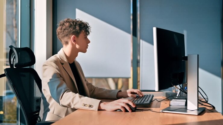 Young man is working in a computer in an office. Slow motion