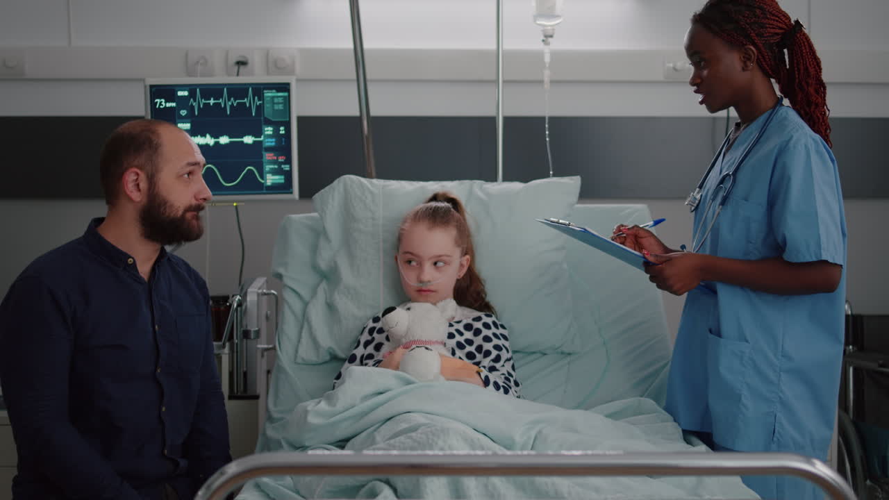 Mother discussing medical treatment with pediatrician doctor during disease examination