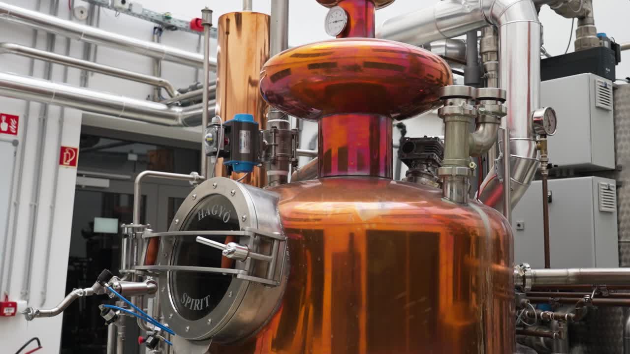 Close-up of copper distillery equipment with pipes