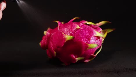 water misting over vibrant dragon fruit