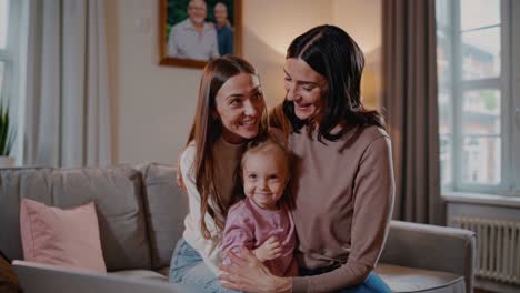 happy family portrait of a lesbian couple and their child