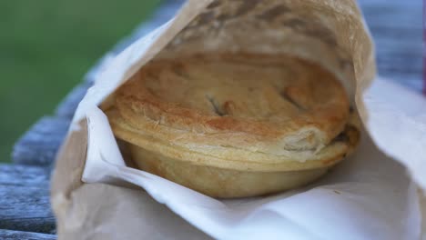 freshly bake traditional meat pie on wooden table in new zealand