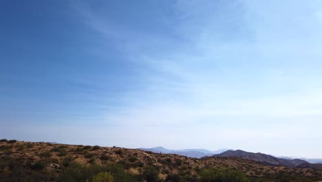 Off-in-the-distance-rows-of-mountain-ridges-pop-out-of-the-Sonoran-Desert,-Scottsdale,-Arizona