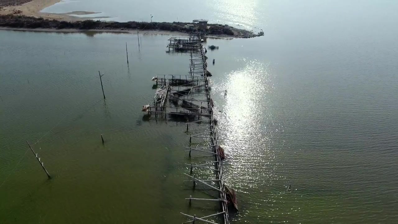 Aerial View of Dilapidated Wooden Fishing Pier in Calm Water