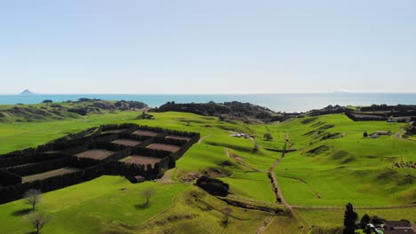 picturesque flowing green hills of famous countryside in new zealand, aerial pull back