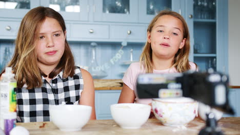 two girls recording vlog at home showing how to make slime