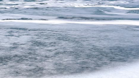 View-of-beautiful-sea-waves-on-the-beach,-Aerial-view-of-ocean-shoreline,-deep-blue-ocean-water-and-foamy-waves