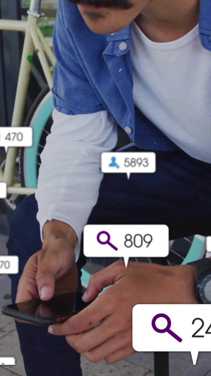 Using smartphone, man surrounded by animation of social media notifications outdoors