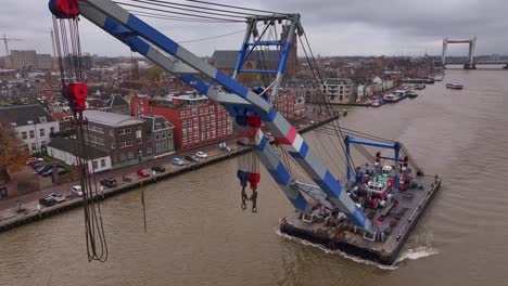 crane, firmly anchored on the platform, extends its mechanical arms upwards