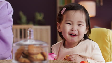 asian baby sitting on baby chair