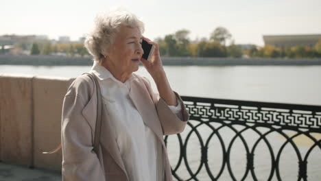 senior woman talking on phone outdoors