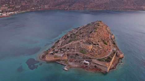 aerial view of a historic fortress island near the coast at sunset