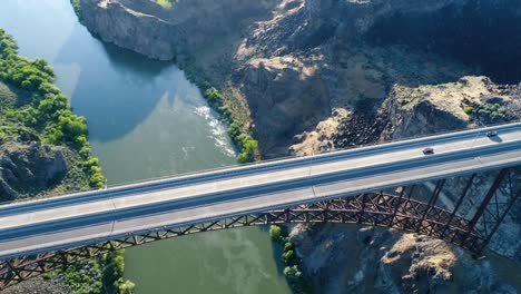 a 4k fly-over drone shot of perrine bridge, a 1,500 foot long bridge, spanning over the snake river in twin falls, idaho