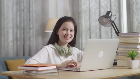 teenage girl studying at home