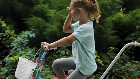 beautiful and happy baby riding a bike in the summer