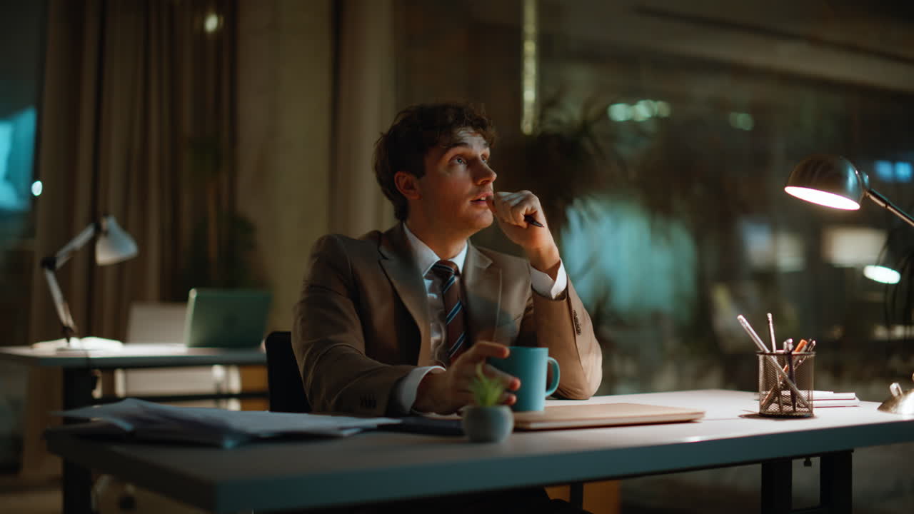 Businessman drinking coffee night office closeup. Smiling overtime worker break