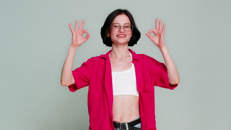 young woman smiling nodding showing okay gesture with fingers positive approval agreement reaction