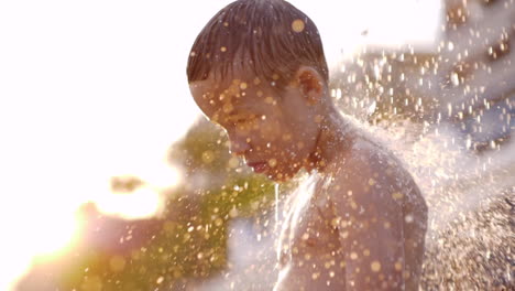 Kid-taking-beach-shower-view-against-sunlight