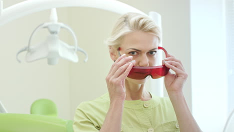 portrait of stomatologist holding dental curing light for oral cavity