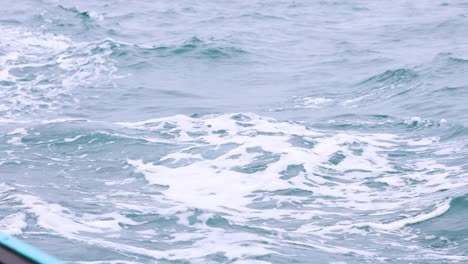 boat wake in rainy ocean environment