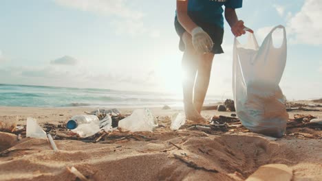 caucasian woman environmental activist cleaning beach from nondegradable waste