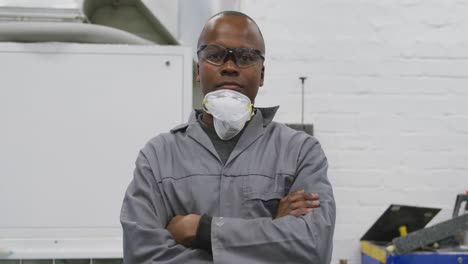 african american male car mechanic crossing his arms and looking at the camera