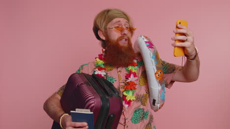 man in hawaiian shirt with suitcase, passport, and inflatable ring, ready for vacation