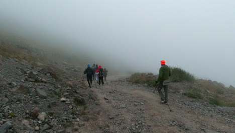 hikers in foggy mountain