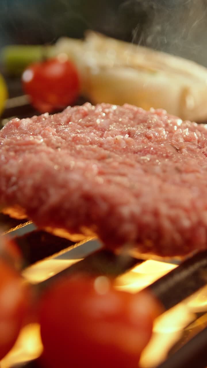 Burger on the grill with tomatoes