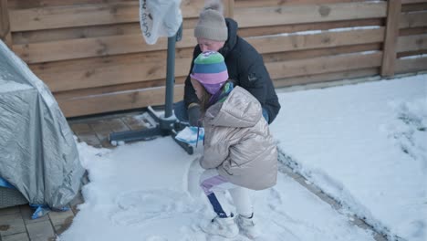 grandfather and granddaughter having fun in the snow