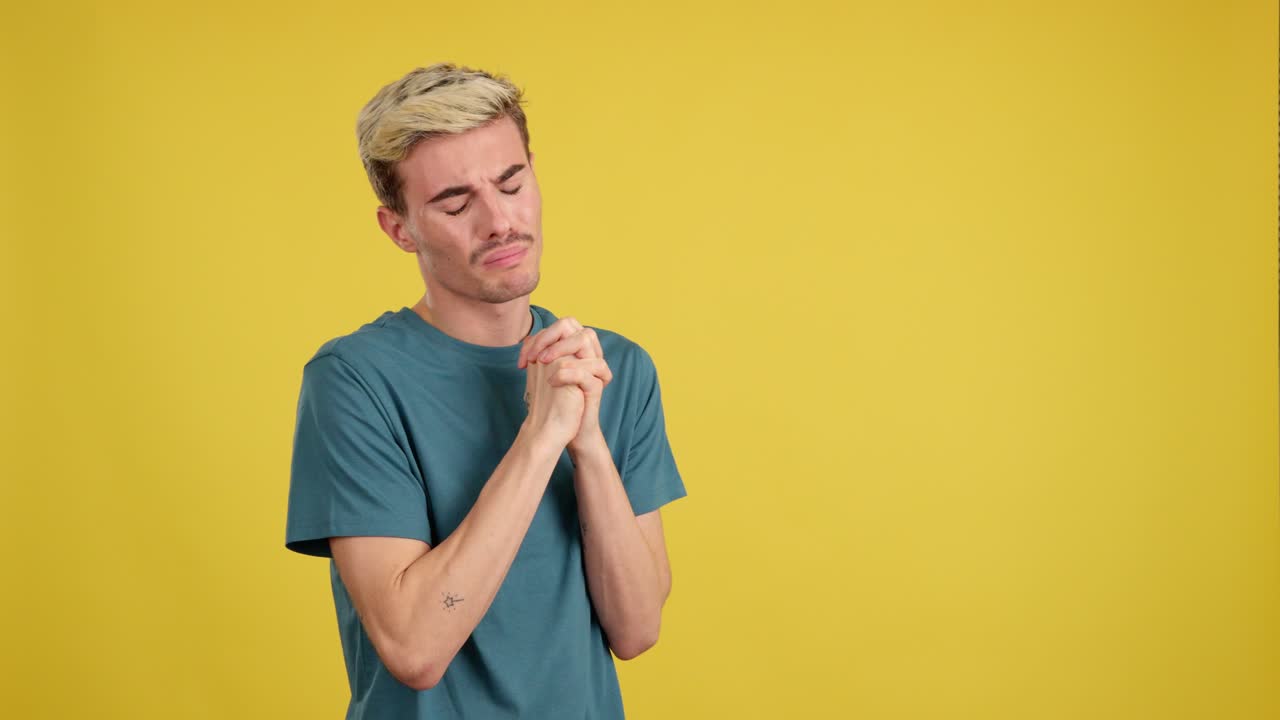 Man Praying on Yellow Background