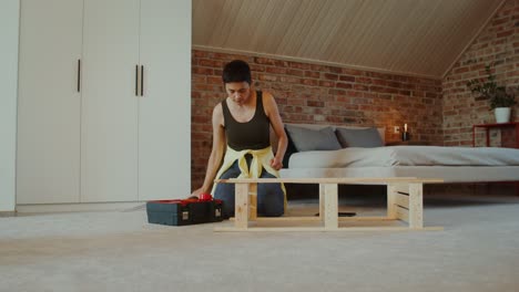 mujer montando muebles de madera