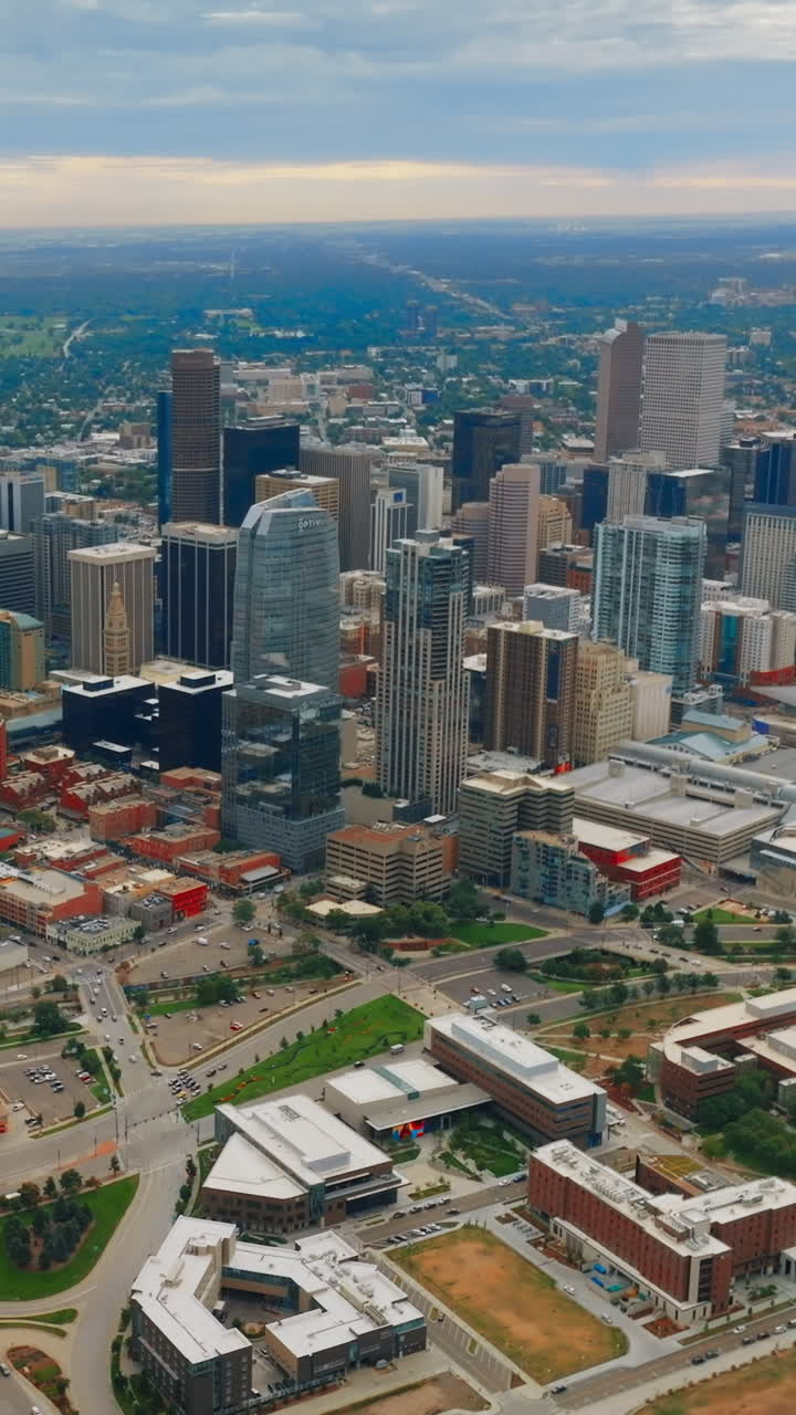 Skyscrapers of Denver, Colorado, United States on gloomy daytime. Densely built urban scenery from aerial perspective. Vertical video