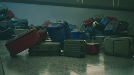 a pile of suitcases at an airport