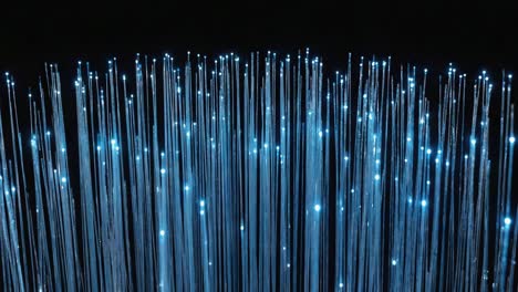 glowing blue fiber optic cables on black background