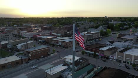 american flag in small town midwest america, aerial dolly