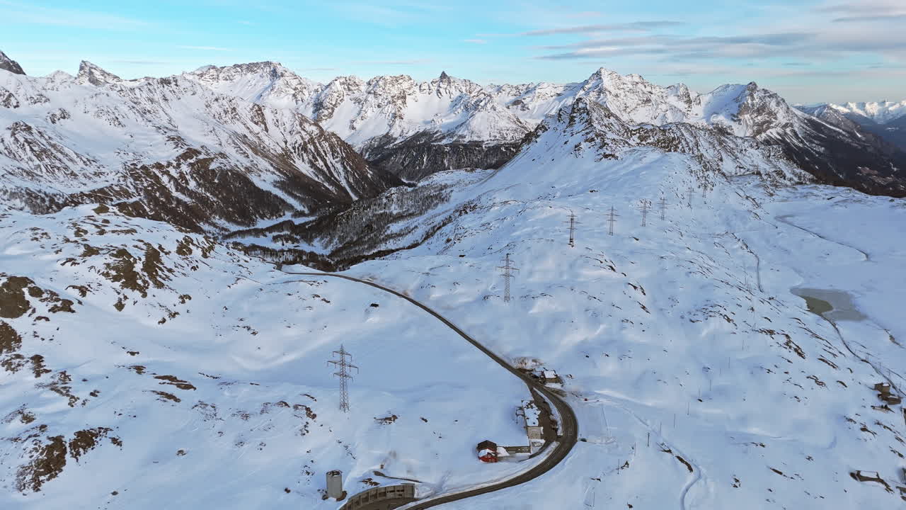 Serene winter landscape of Bernina Pass, snowy peaks and winding road