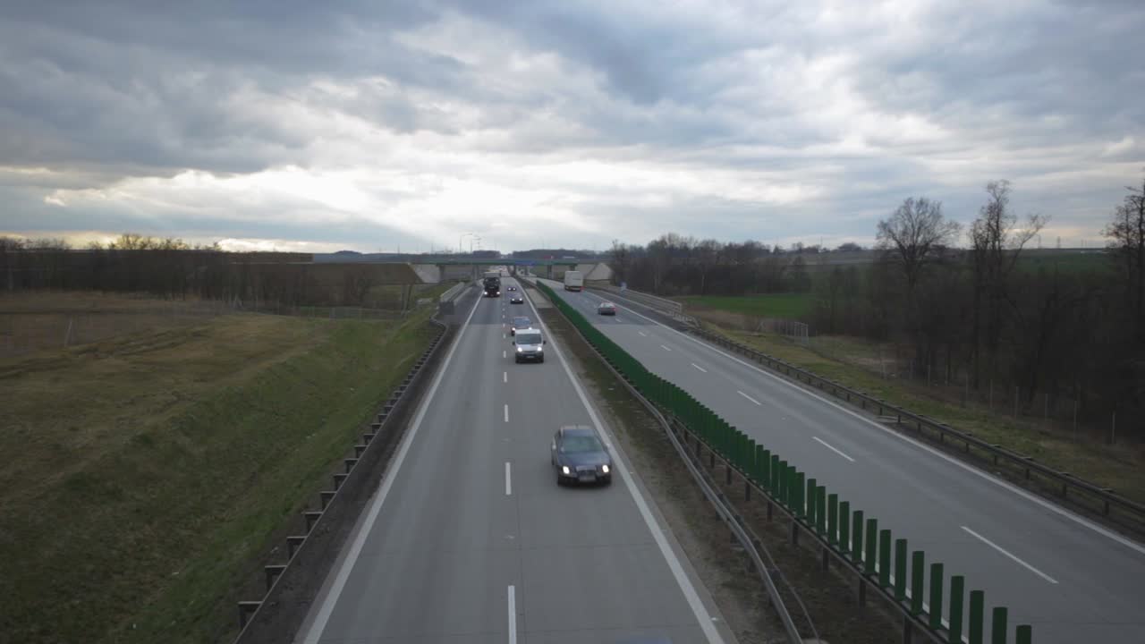 Cargo Trucks And Cars Driving On The Highway In Zlotoryja, Poland At Dusk - tilt-up shot