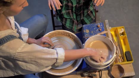 slow motion, woman works with pottery wheel in a workshop