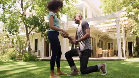 Happy-mixed-race-couple-enjoying-in-the-garden-during-a-sunny-day