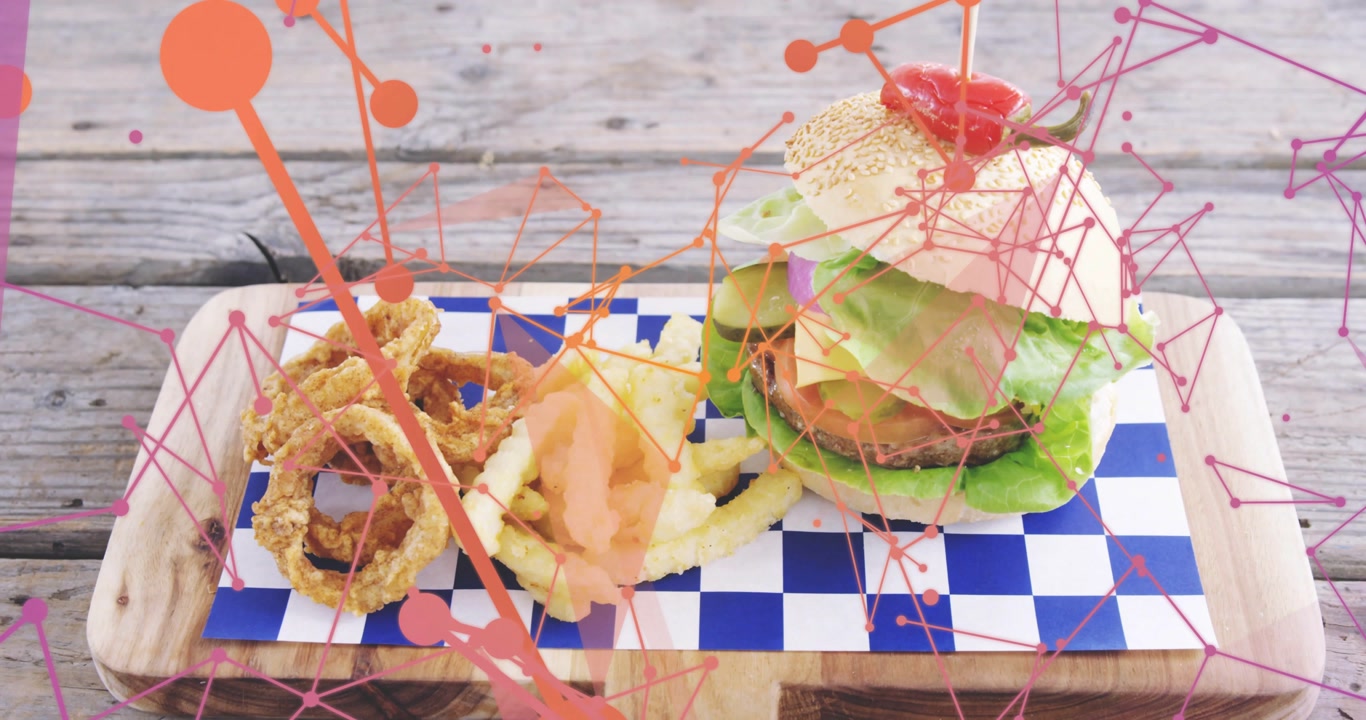 Camera pulling back revealing burger and sides on checked board, food overlays promoting menu