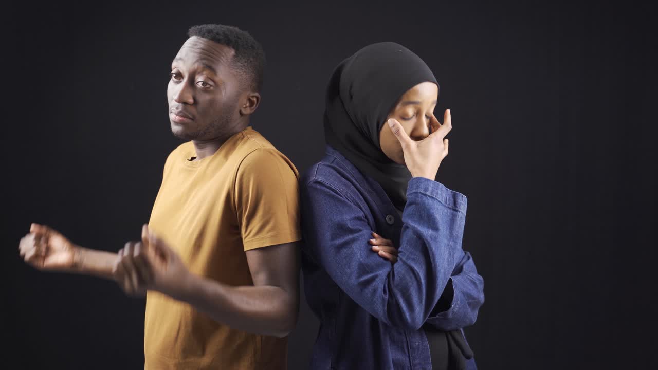 Muslim African couple are unhappy and overwhelmed in their marriage or relationship.