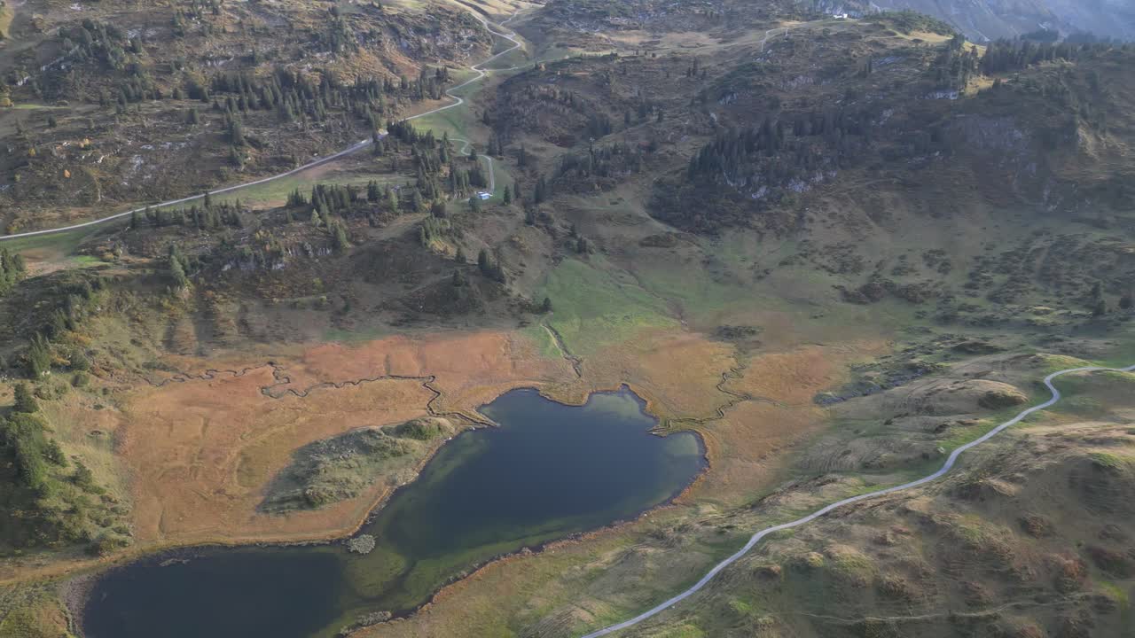 A stunning aerial view of the Austrian Alps, with lush green hills surrounding the picturesque K&ouml;rbersee and Kalbelesee lakes
