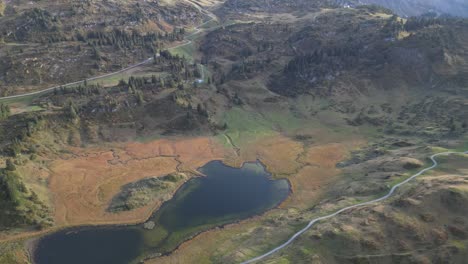 A-stunning-aerial-view-of-the-Austrian-Alps,-with-lush-green-hills-surrounding-the-picturesque-Körbersee-and-Kalbelesee-lakes